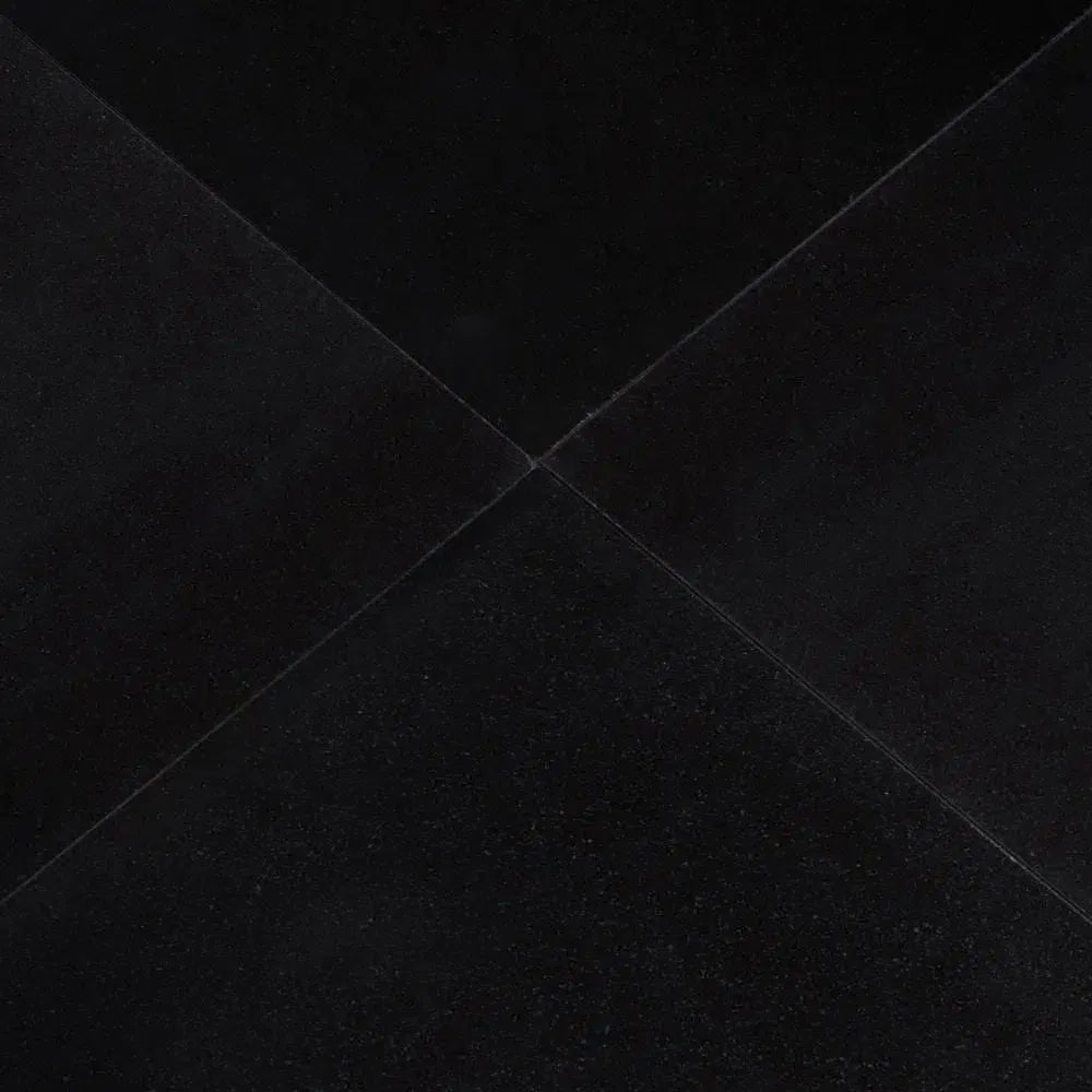 Folded black fabric showcasing Absolute Black 12X12 Granite Polished finish