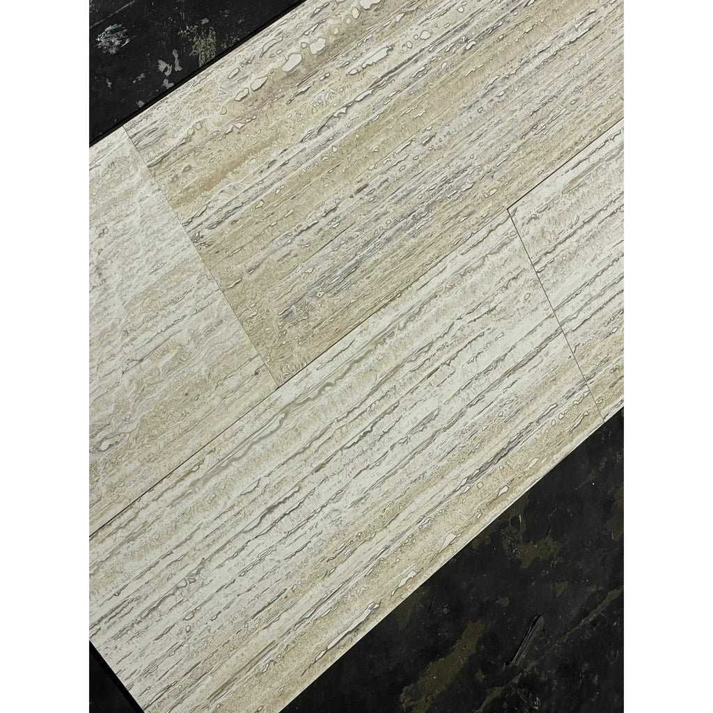 Beige wood-look flooring planks in Alabastrino Rustic White Vein-Cut Travertine finish