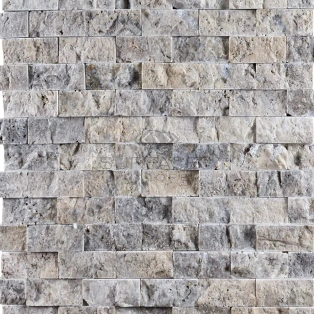 Gray and beige stacked stone wall featuring Atlantic Gray Marble 1X2 Brick Mosaic Split-Faced