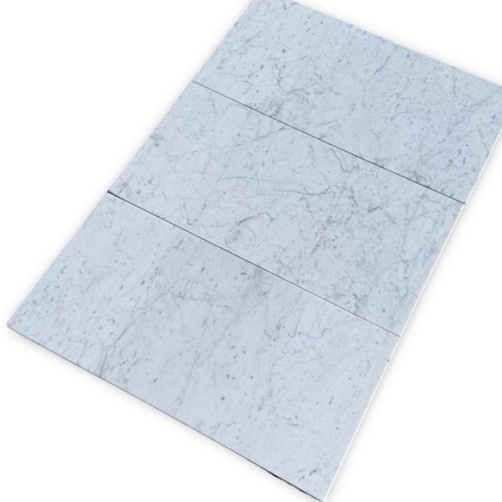 Three marble-patterned tiles from the Bari in Ming Green and Carrara White set