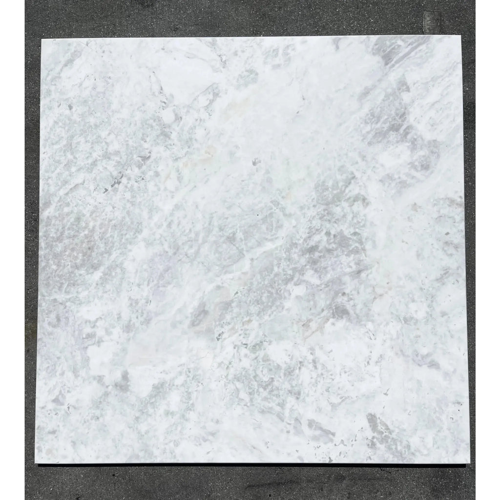 Square marble tile with gray veining in Bianco Congelato Dolomite Leathered finish