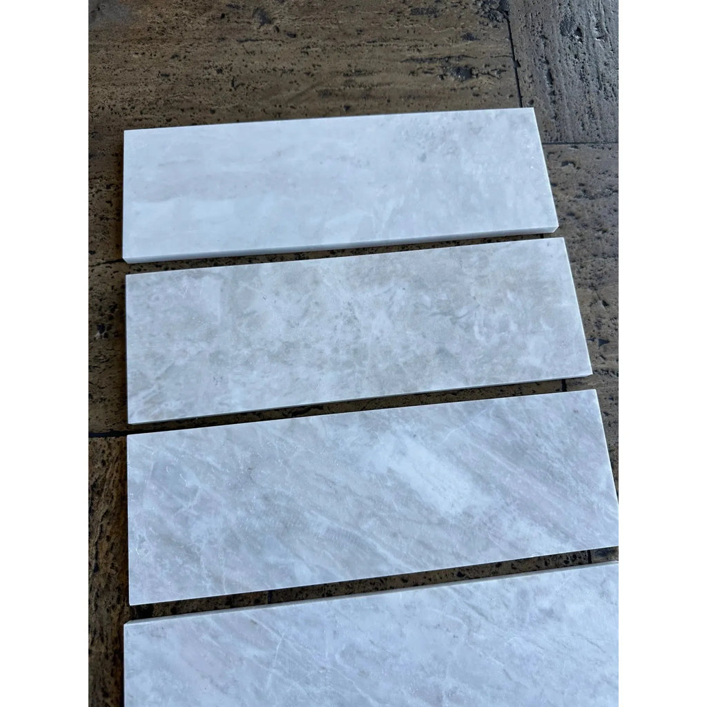 Rectangular marble tiles in Bianco Congelato 2X12 OG-1 single-step chair rail trim