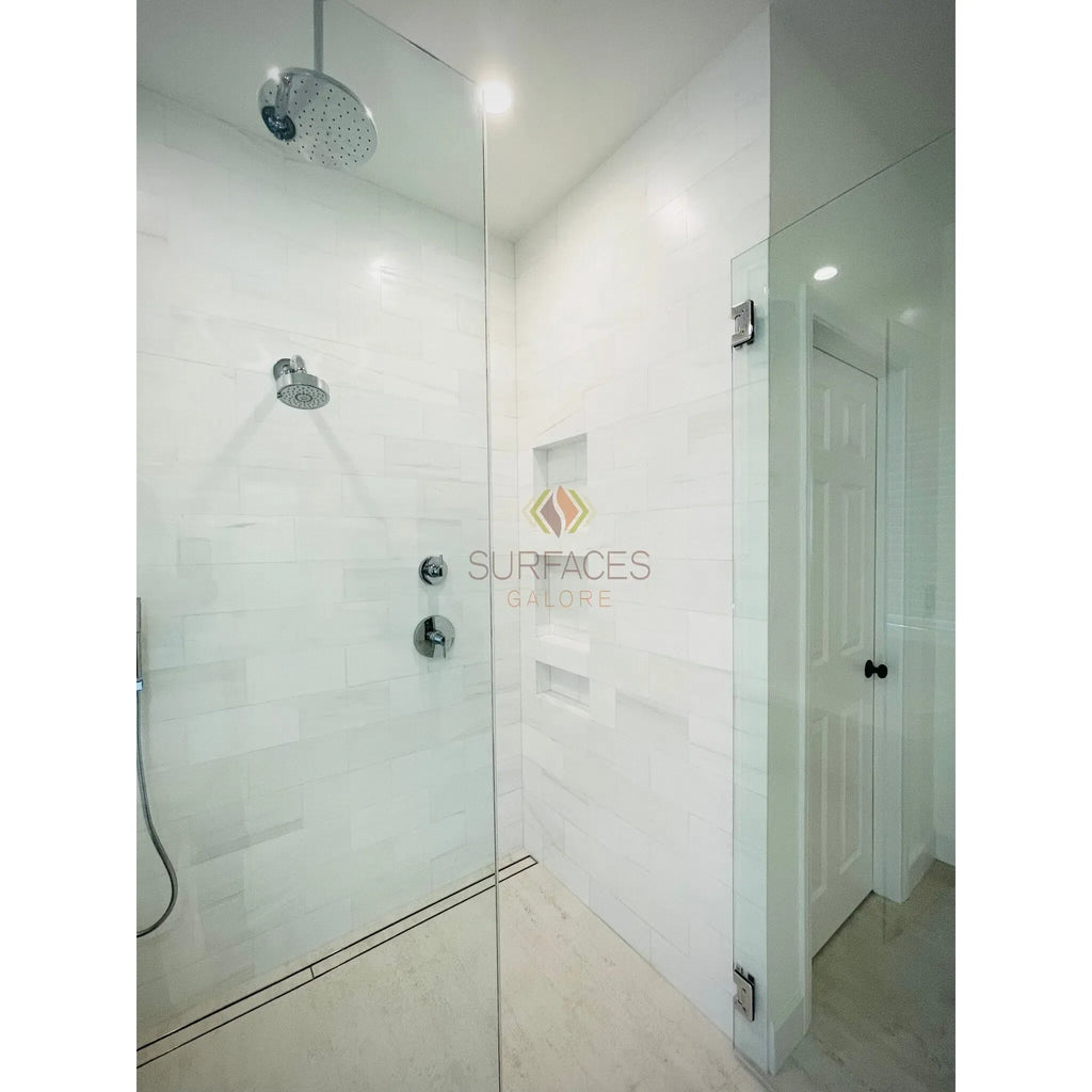 Modern white marble shower featuring Bianco Dolomite 1/2X12 Pencil Liner