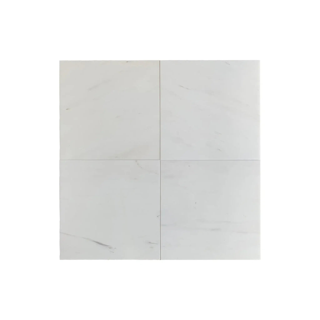 Four white square tiles of Bianco Dolomite 1/2X12 Pencil Liner Marble