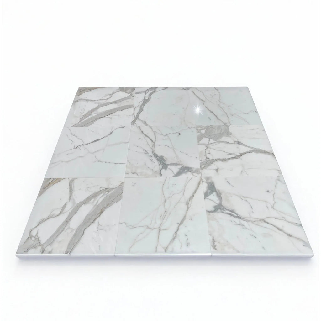 White marble tile arrangement featuring Calacatta Gold 1/2X12 Pencil Liner polished finish