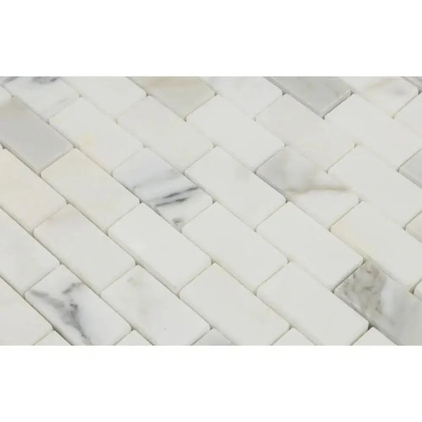 Calacatta Gold 1x2 Brick Mosaic Marble Tile in polished white marble herringbone design