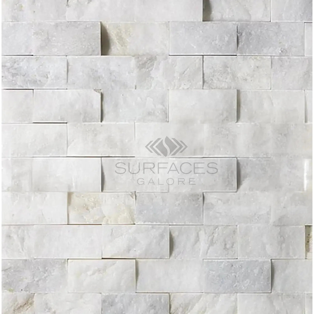 White stacked stone wall featuring Calacatta Gold 1X2 Brick Split-Faced Mosaic Marble Tile