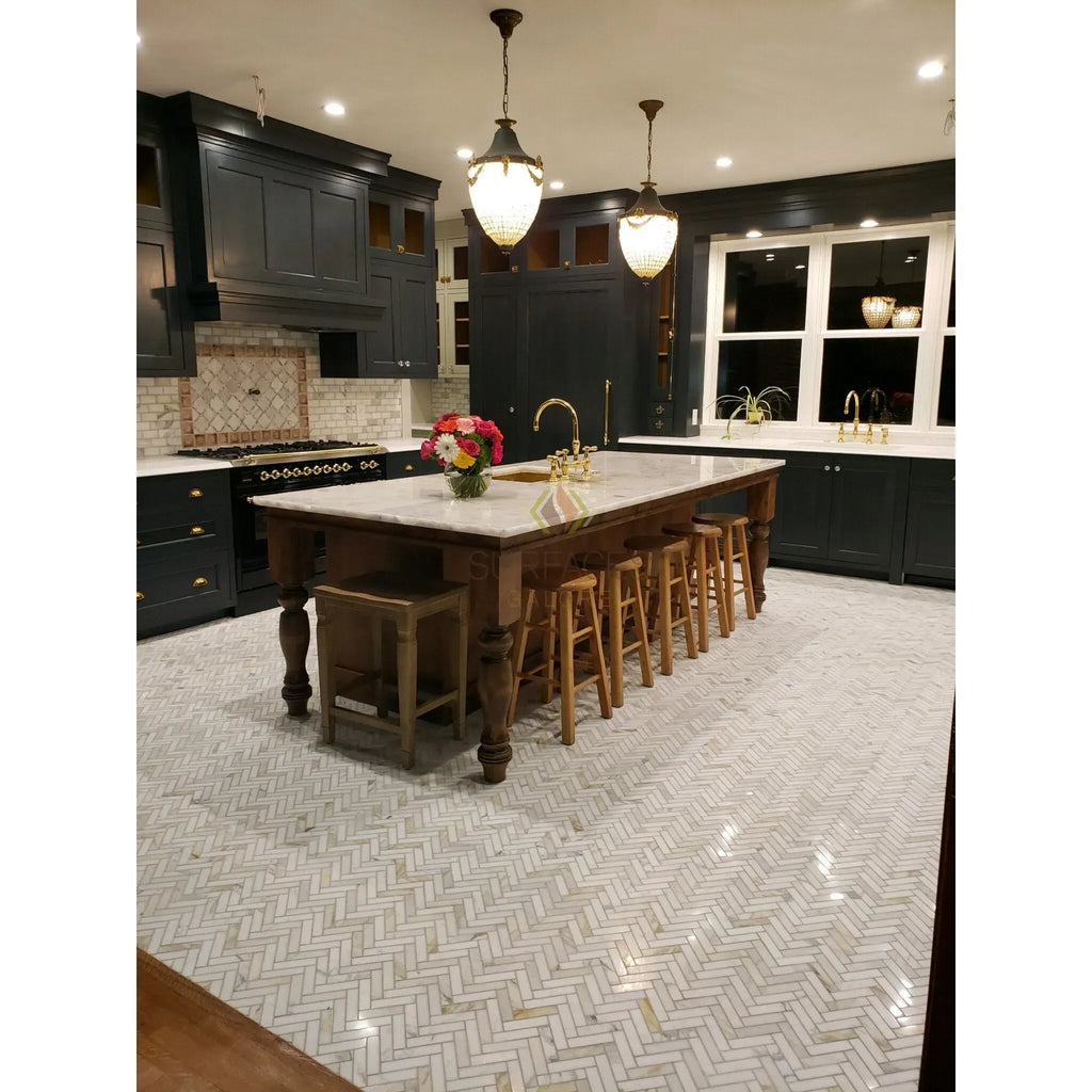 Elegant kitchen island featuring Calacatta Gold marble countertop and herringbone tile