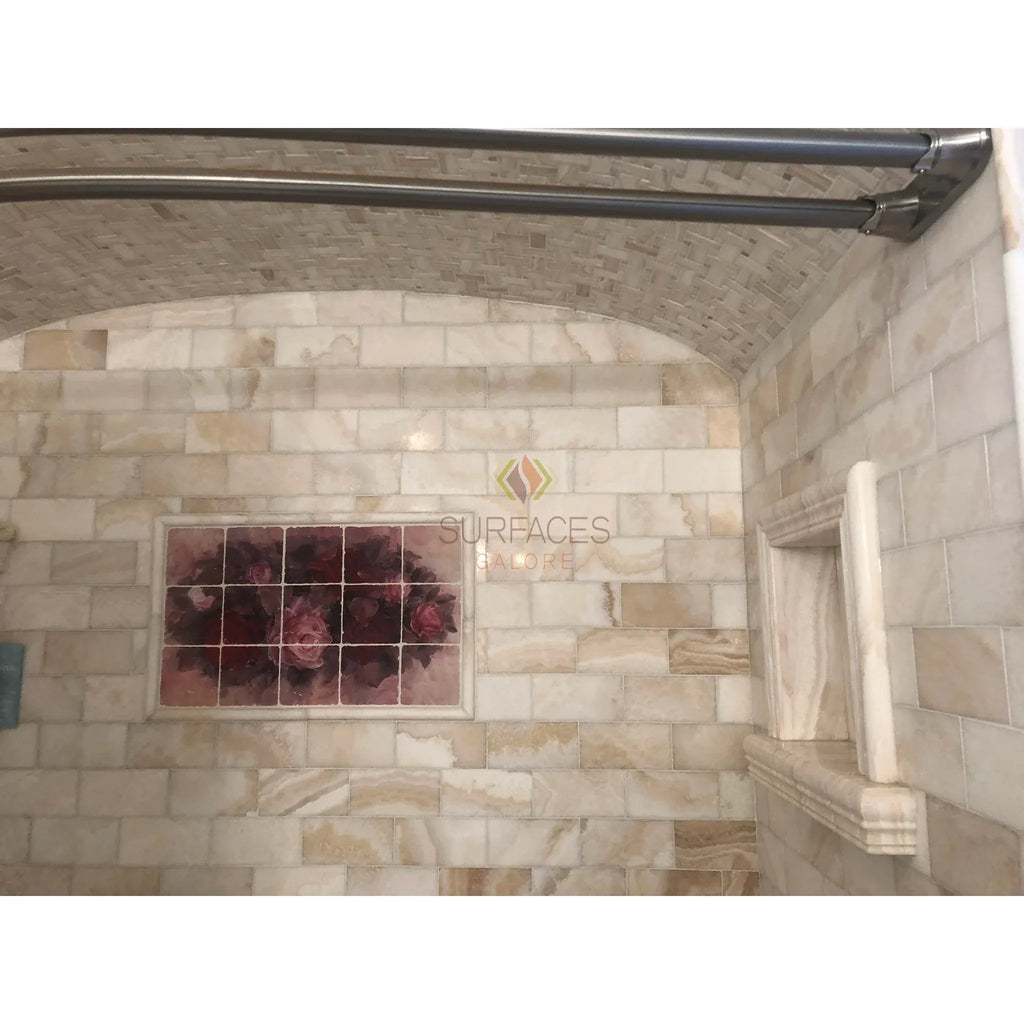 Tiled shower featuring arched ceiling with Calacatta Gold Herringbone Mosaic Marble Tile