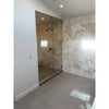 Modern glass shower enclosure featured with Calacatta Gold baseboard trim molding