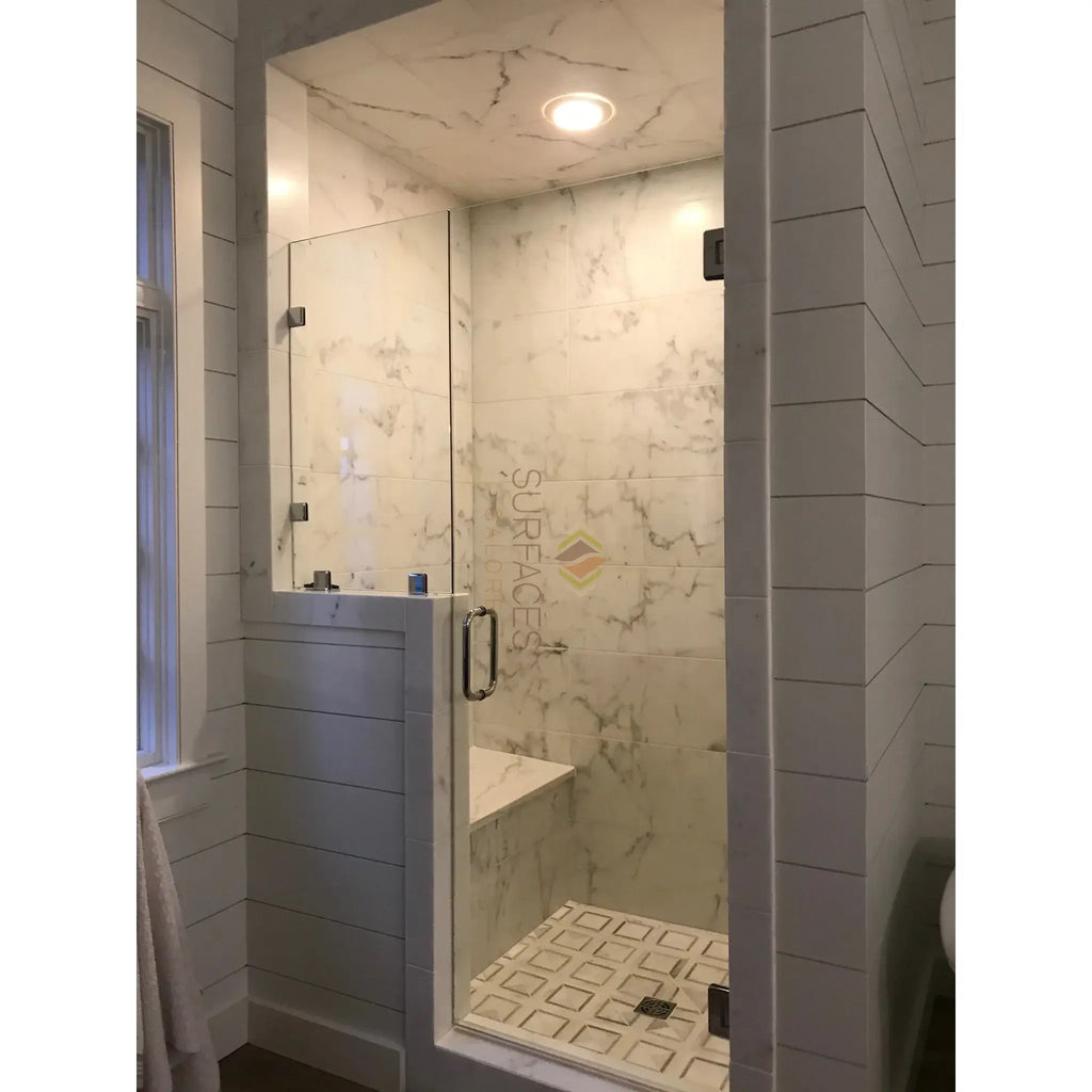 Modern marble shower stall featuring Calacatta Gold baseboard trim molding