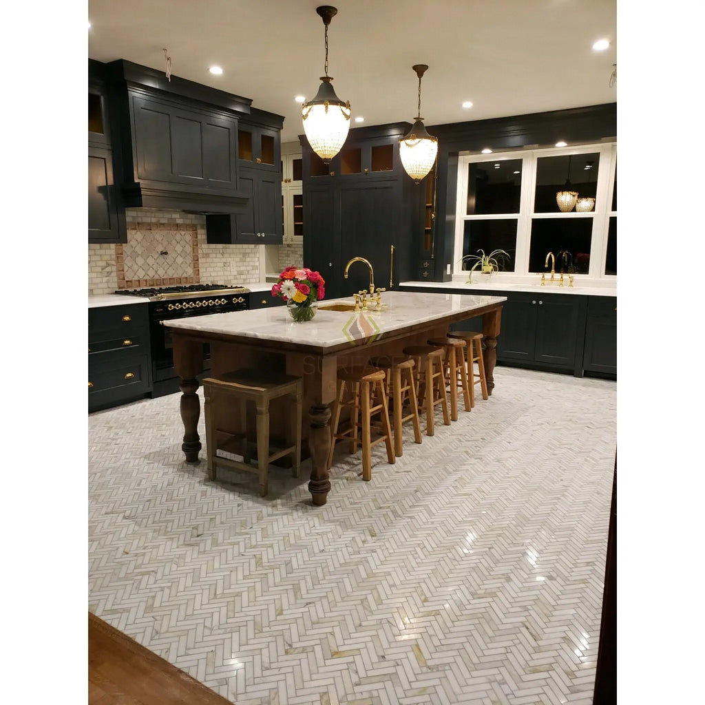 Elegant kitchen island with Calacatta Gold marble countertop and baseboard trim molding