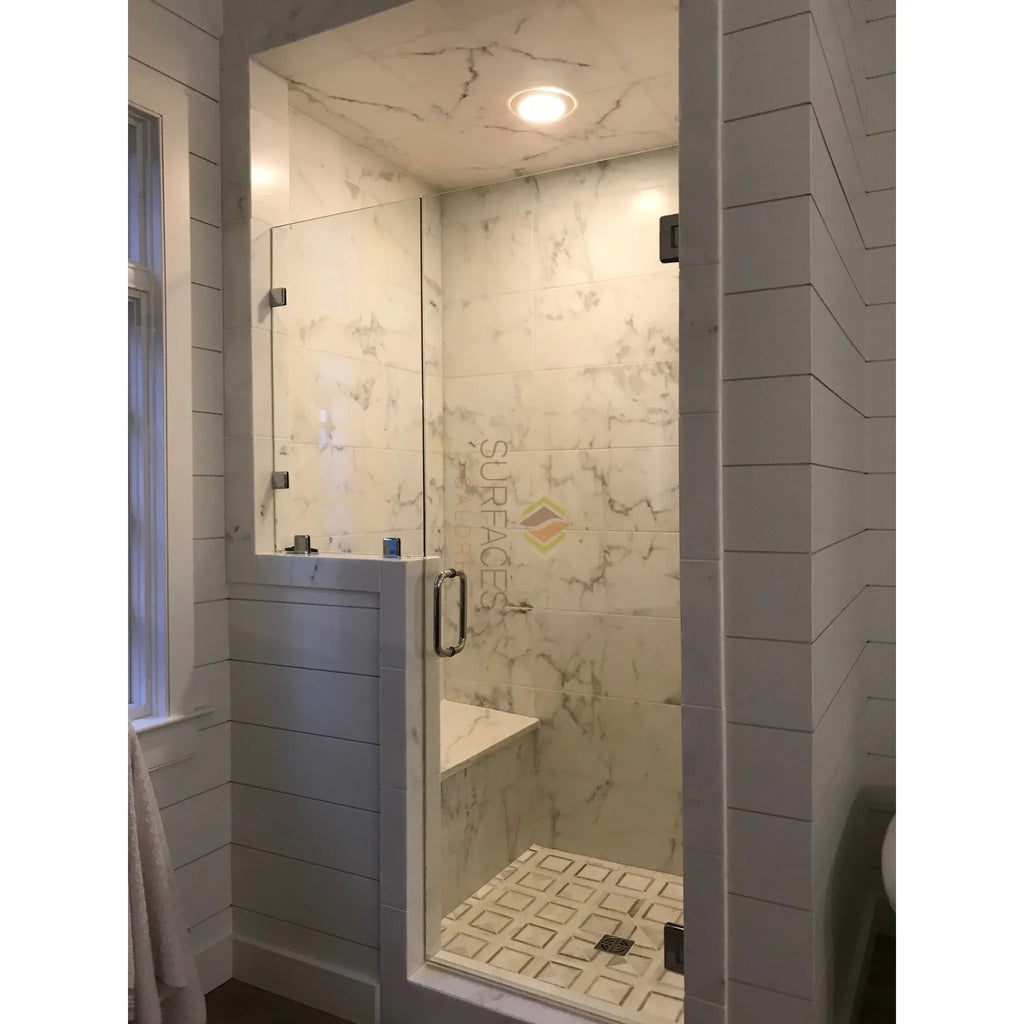 Modern marble shower stall featuring a Calacatta Gold Italian marble corner shelf