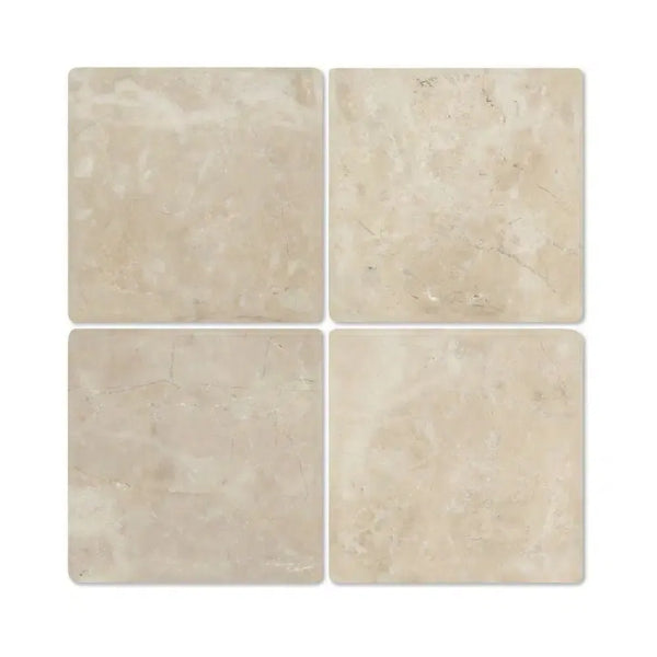 Four beige Cappuccino Marble 4X4 Tumbled tiles showcasing elegant natural design