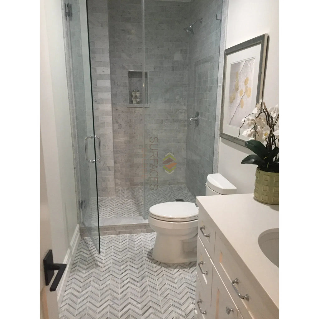 Modern bathroom featuring glass shower with Carrara White 2’’ Hexagon Marble Tile