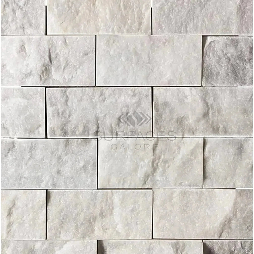 Carrara White 2X4 Brick Mosaic Marble Tile Split-Faced on a white stone brick wall