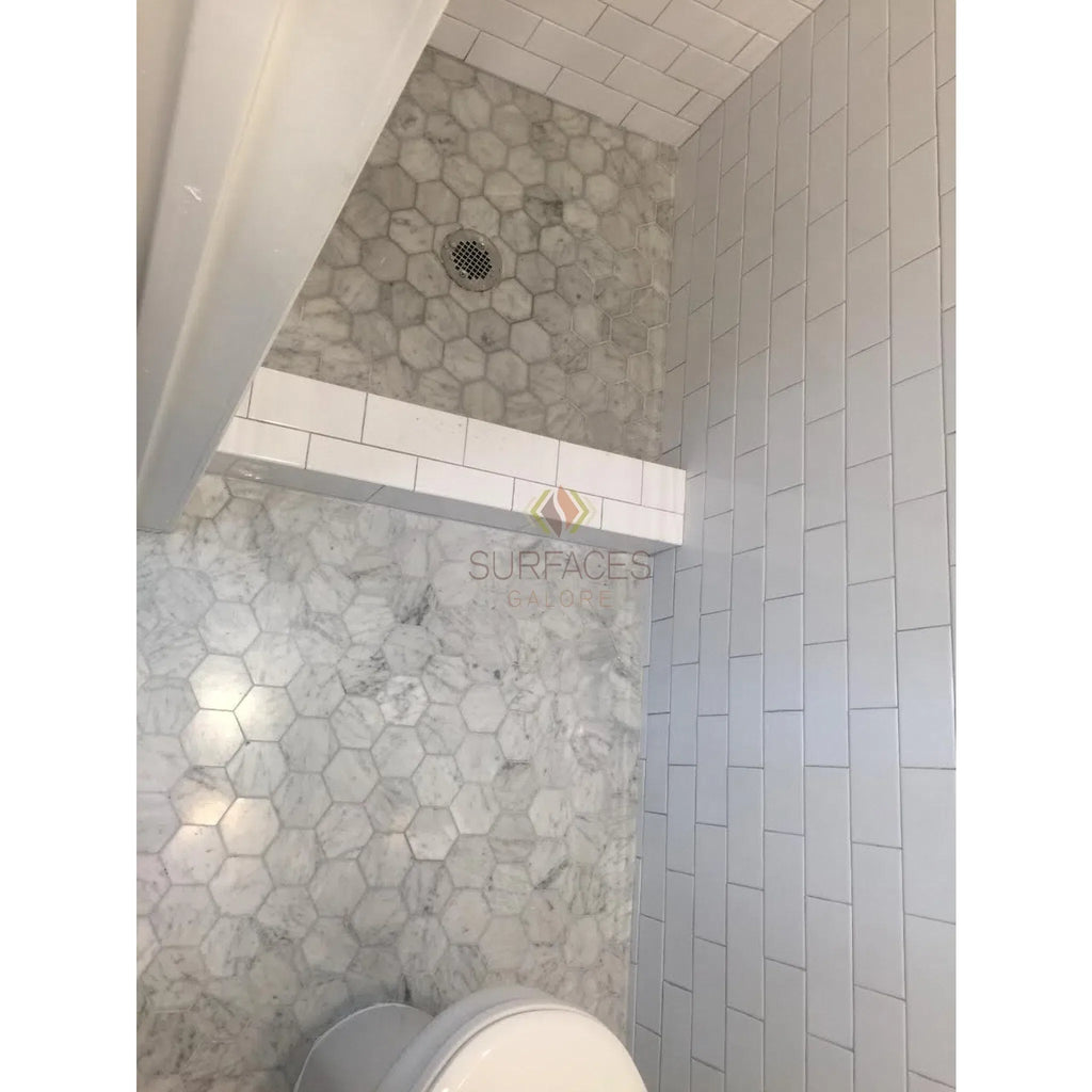 Tiled bathroom interior featuring Carrara White Greek Key Border in polished finish