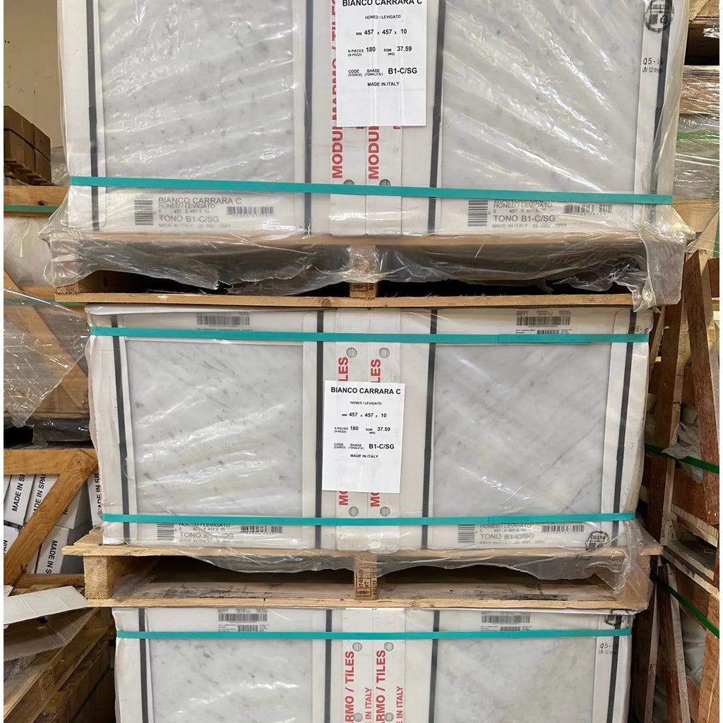 Stacked pallets of Carrara White 5/8X1 1/4 Mini-Brick Mosaic Marble Tile