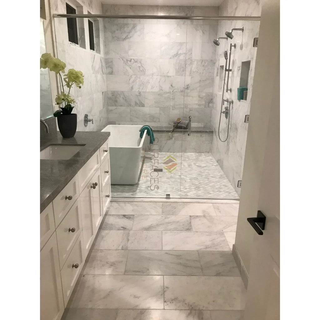 Marble-tiled bathroom featuring Carrara White Mini-Brick Mosaic and glass shower