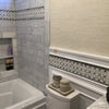 Elegant Bathroom featuring Carrara White Marble Tile and Decorative Border in Shower Shelf