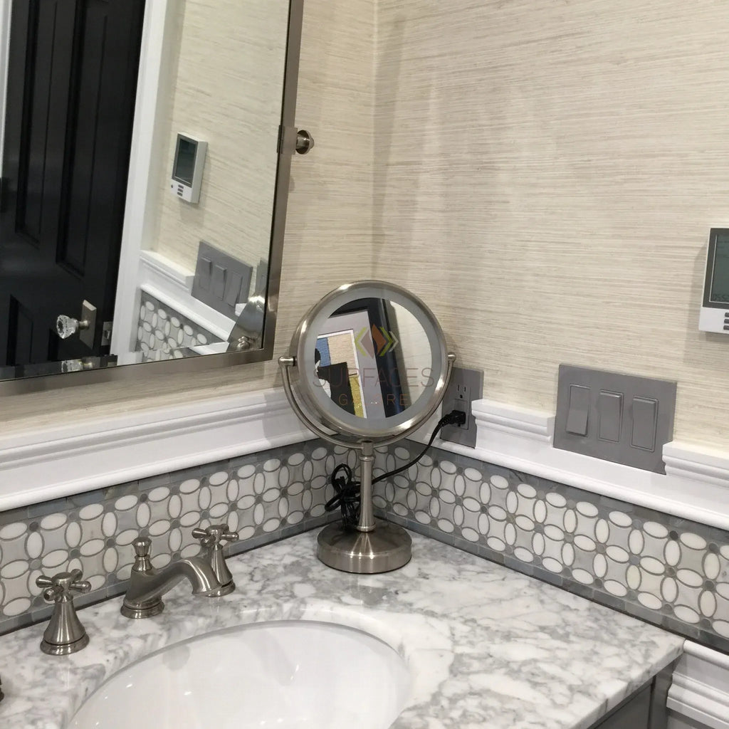 Illuminated vanity mirror showcasing Carrara White Herringbone Mini Marble Tile