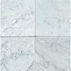 Four Carrara White Marble 12X12 Tumbled tiles showcasing elegant design