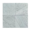 Four Carrara White Marble 12x12 Tumbled tiles displaying elegant veining and finish