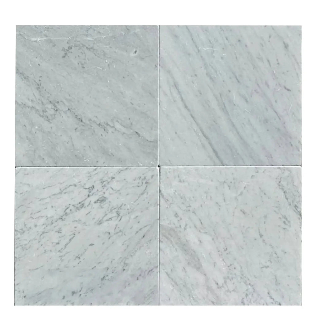 Four Carrara White Marble 12X12 Tumbled tiles showcasing elegant natural textures