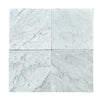 Four Carrara White Marble 12X12 Tumbled tiles showcasing elegant natural design