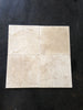 Four beige travertine tiles from Checkerboard Nero Marquina Marble and Ivory Tumbled Set