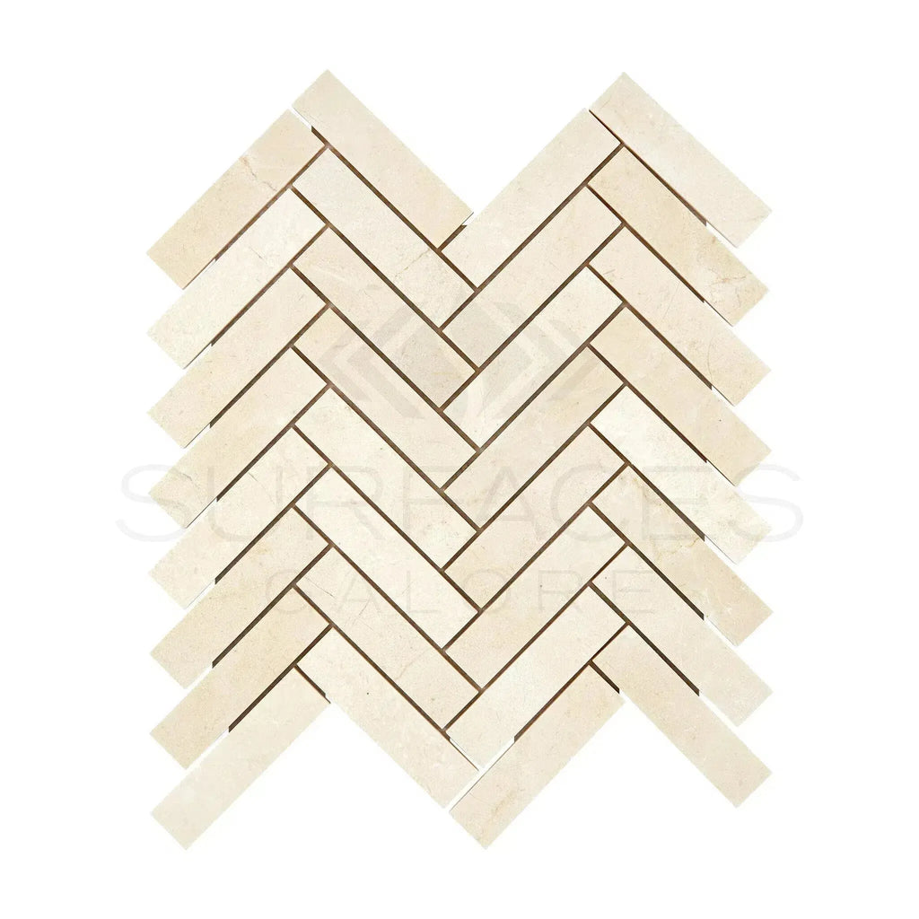 Herringbone pattern of light-colored Crema Marfil Marble 1X4 mosaic tiles