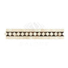 Decorative marble tile border featuring Crema Marfil Marble with polished dark dots