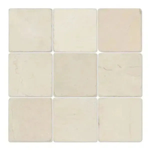 Nine off-white Crema Marfil Marble 4X4 Tumbled tiles arranged in a square pattern