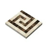 Square mosaic tile featuring Greek key pattern in Crema Marfil Marble border corner