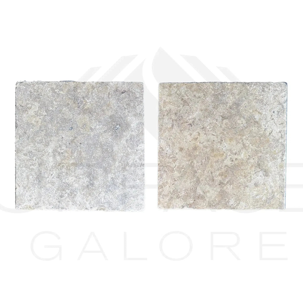 Two square textured stone tiles from Dore Reale Light Golden Beige Tumbled Tile