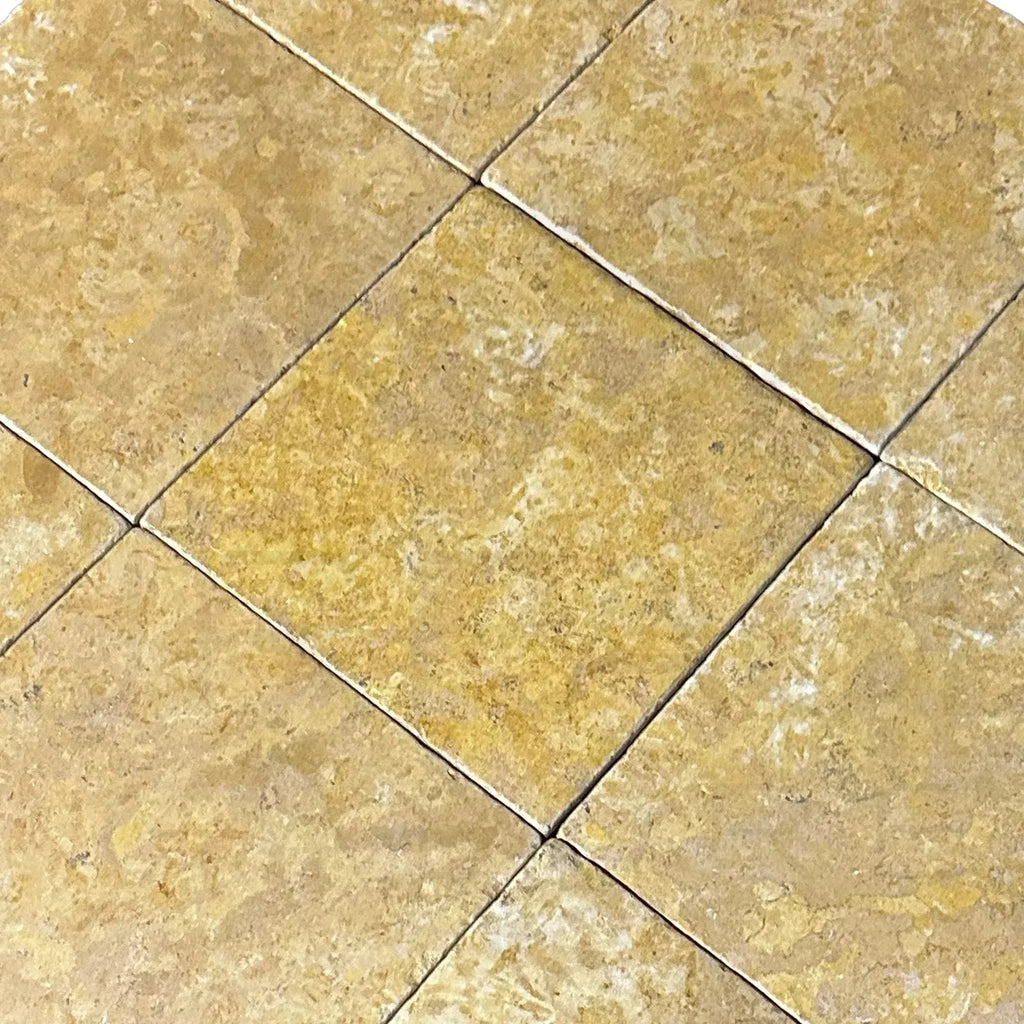 Tiled tan-colored stone squares from Dore Reale Light Golden Beige Tumbled Tile