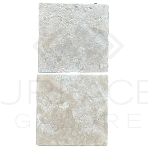 Two textured white stone tiles from the Durango (Santa Fe) 12X12 Tumbled Tile