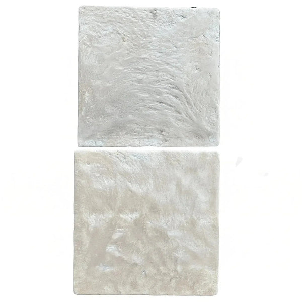 Two textured, square white tiles from Durango Santa Fe 12X12 Tumbled Tile collection