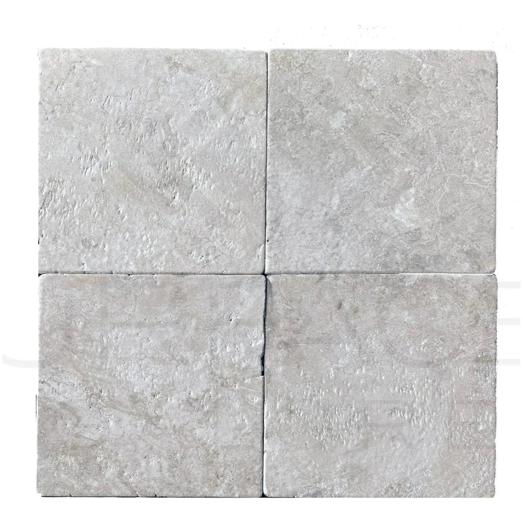 Four square travertine tiles from Durango Santa Fe Tumbled Tile in a 12X12 format