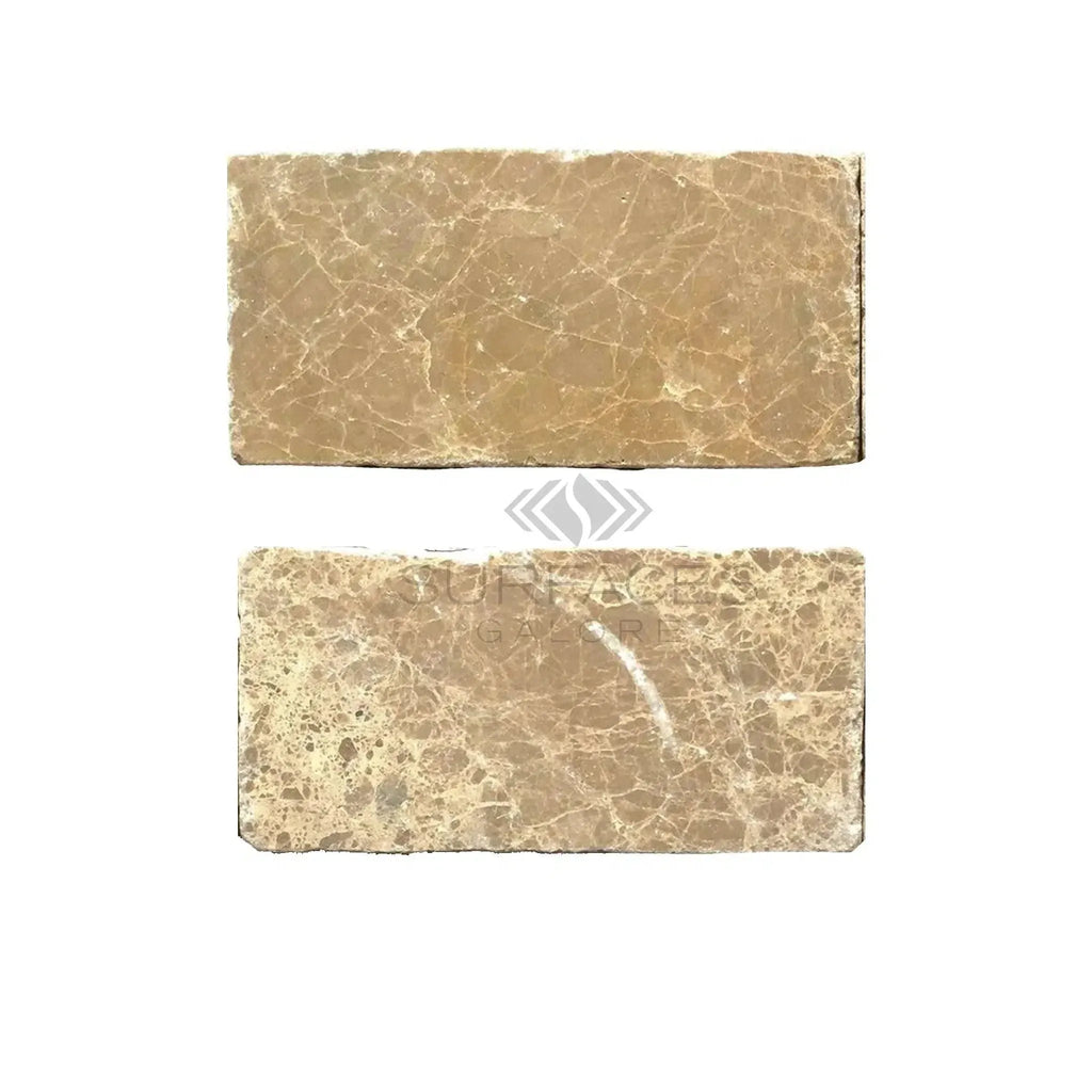 Two rectangular Emperador Light Marble 3X6 Tumbled tiles on a neutral background