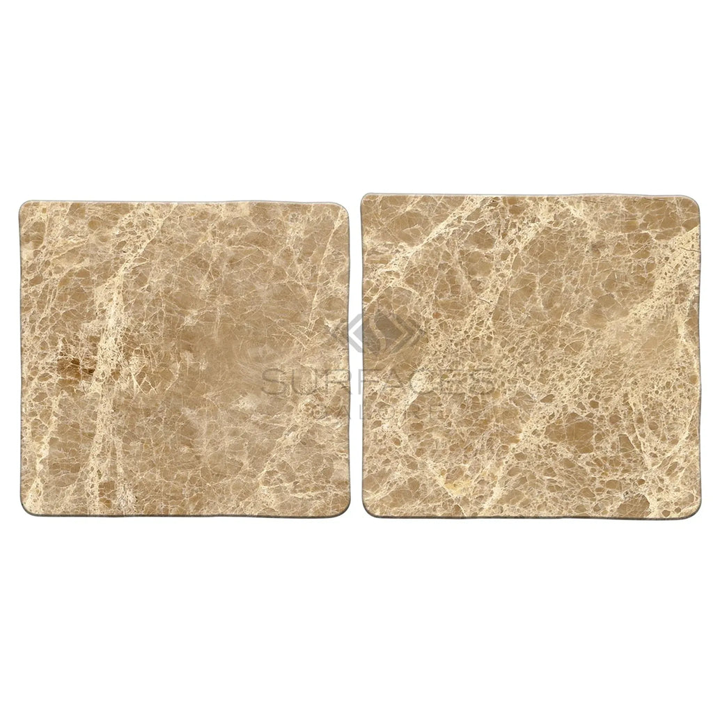 Two square Emperador Light Marble 4X4 Tumbled tiles showcasing elegant design