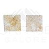 Beige textured square earrings complement Giallo Reale Marble tiles beautifully