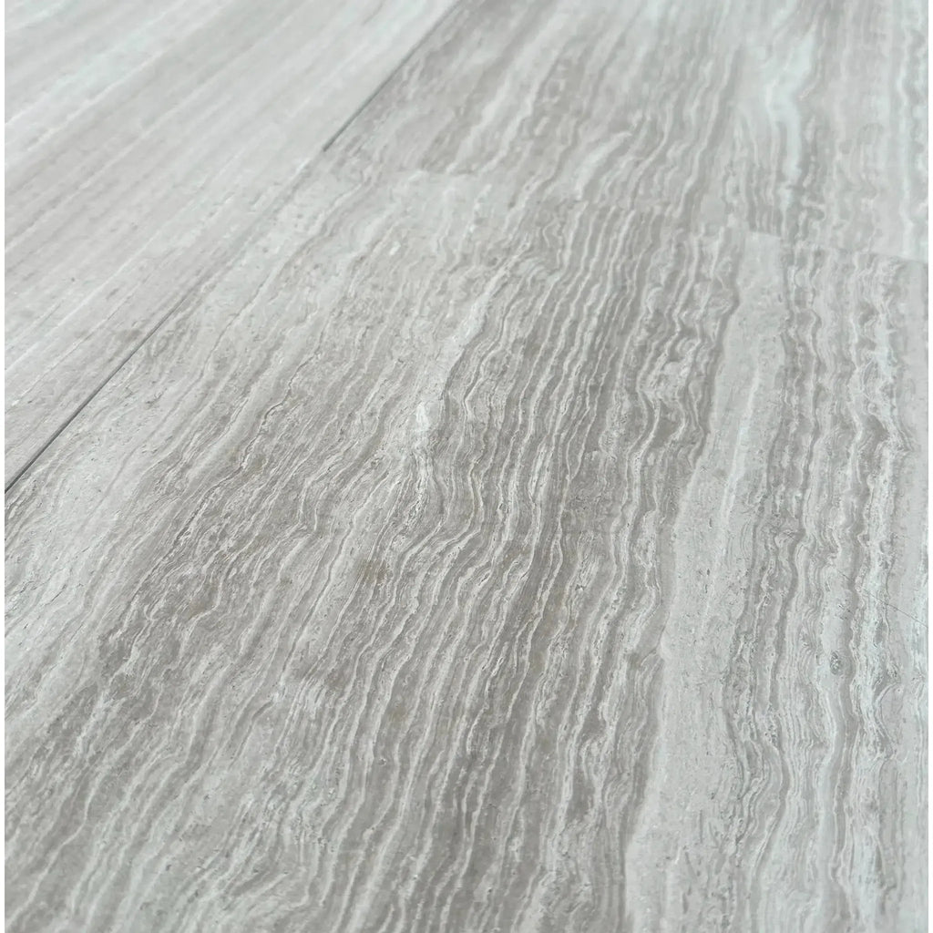 Gray wood-grain flooring in Haisa Light 12X24 Limestone Honed product display