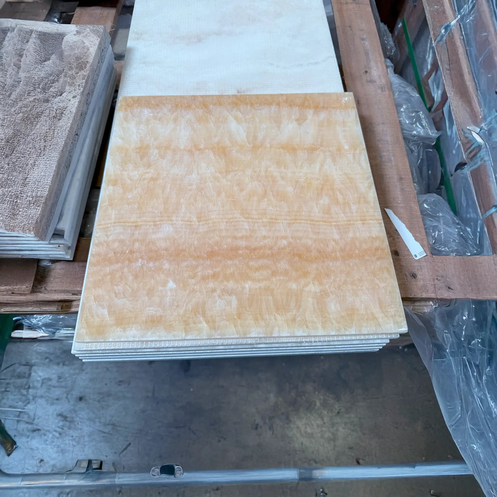 Stacked orange marble tiles of Honey Onyx Giallo Crystal 1/2X12 Pencil Liner Polished