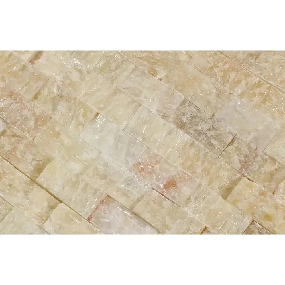 Irregularly stacked translucent light-colored Honey Onyx marble tile mosaic