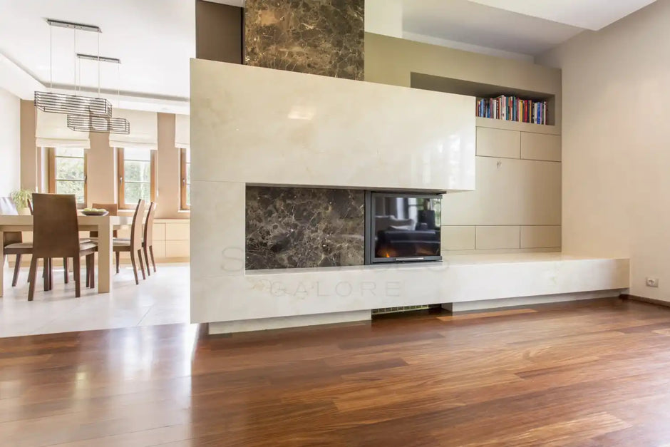 Modern living room with a fireplace, wooden flooring, and a dining area with natural light in the background.