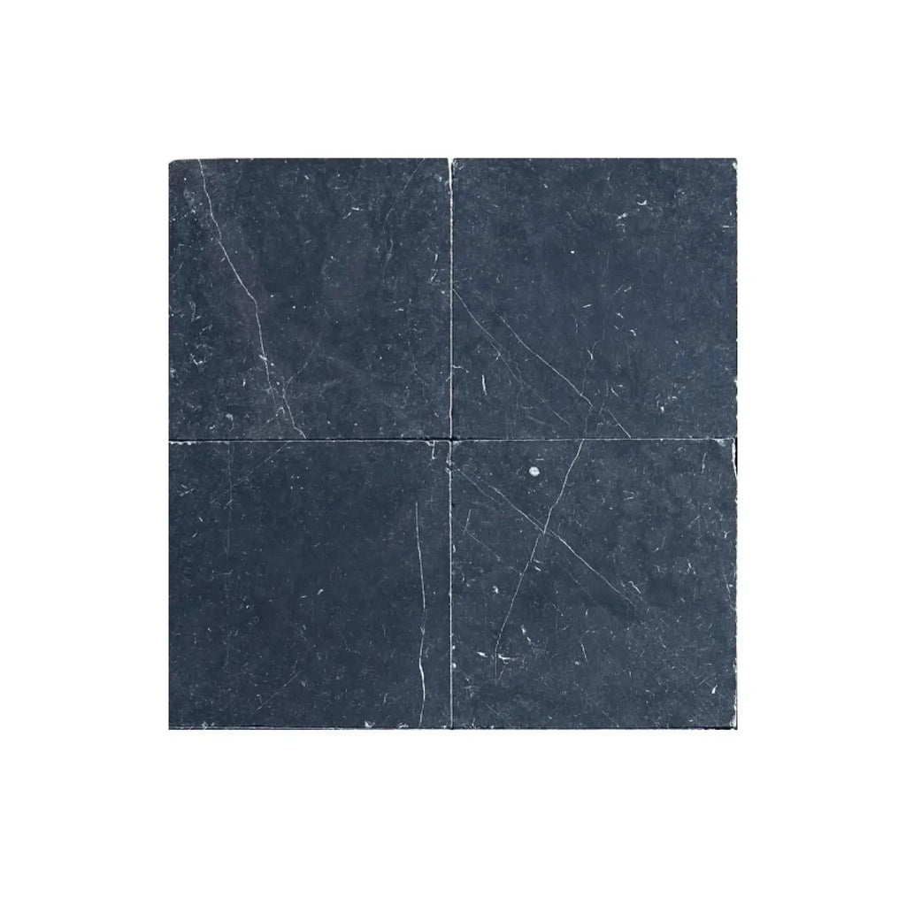 Four dark marble tiles of Nero Marquina Black Marble 12X12 Tumbled design