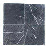 Four gray marble tiles featuring white veining from Nero Marquina Black Marble 12X12 Tumbled