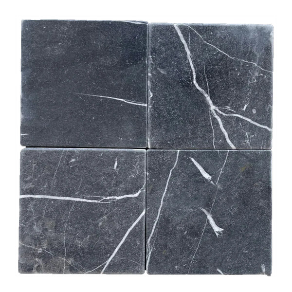 Four gray marble tiles featuring white veining from Nero Marquina Black Marble 12X12 Tumbled