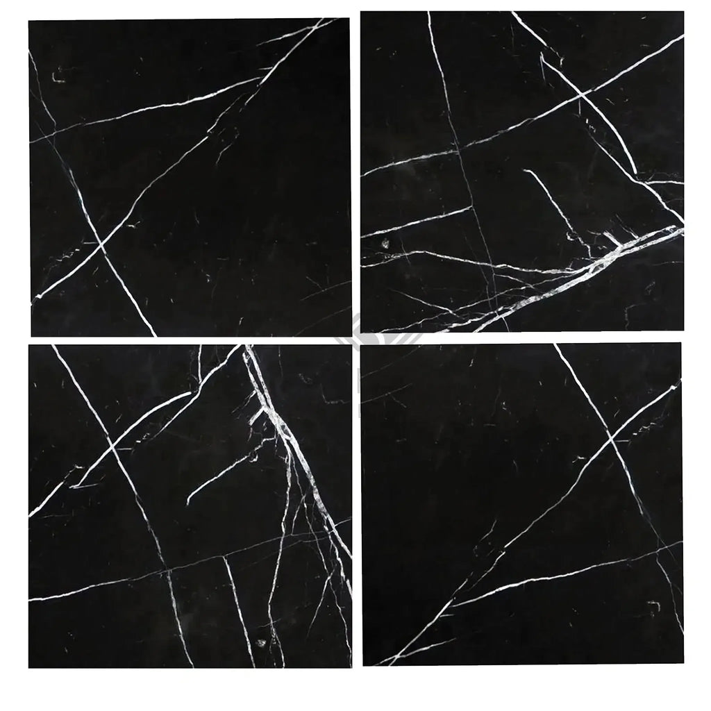 Four black marble tiles with white veining from Nero Marquina Black Marble collection